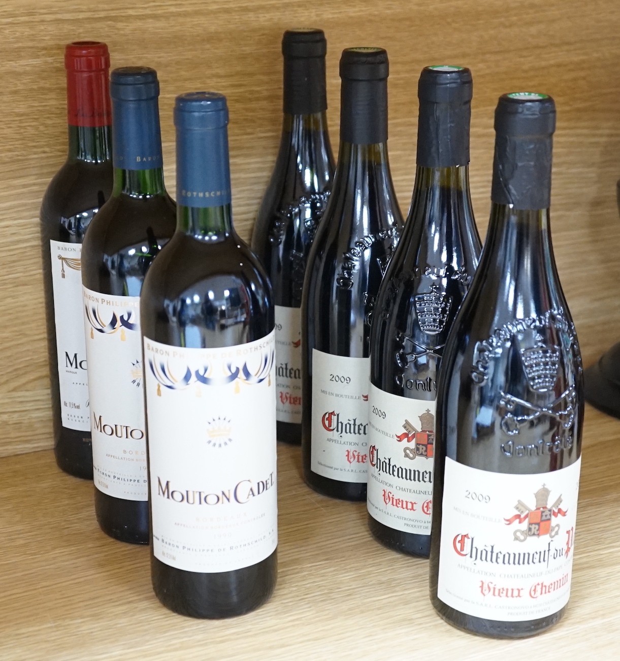 Six assorted bottles of Chateauneuf du Pape and five bottles of Mouton Cadet, 1990.